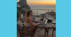 Laptop showing Google search results next to a phone showing an Instagram ad, on a desk overlooking the sea in Marbella